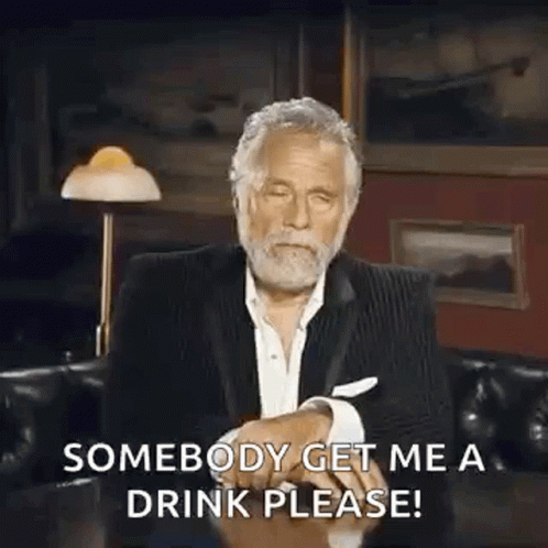 Man in Suit Saying Somebody Get Me a Drink Please