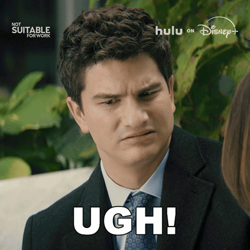 Man in Suit Saying Ugh in Front of Not Suitable for Work Sign