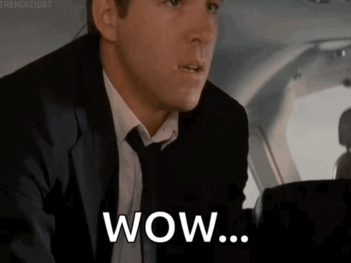 Man in Suit Saying Wow in Airplane