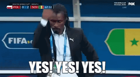 Man In Suit Saying Yes In Front Of FIFA Logo GIF
