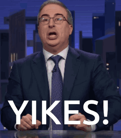 Man In Suit Saying Yikes In Front Of City Skyline GIF