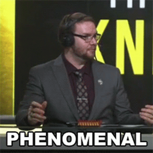 Man In Suit Says Phenomenal In Front Of KN Sign GIF