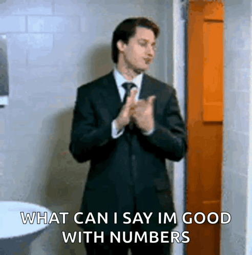 Man in Suit Says What Can I Say Im Good With Numbers in Bathroom