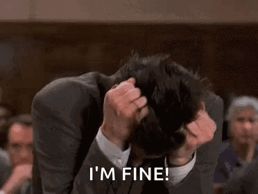 Man in Suit Scratching Head Saying I'm Fine