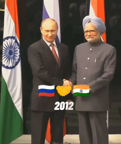 Man In Suit Shakes Hands With Woman In Pink GIF