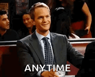 Man in Suit Shaking Hands with Another in Diner
