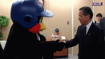 Man In Suit Shaking Hands With Mascot Wearing Baseball Helmet GIF