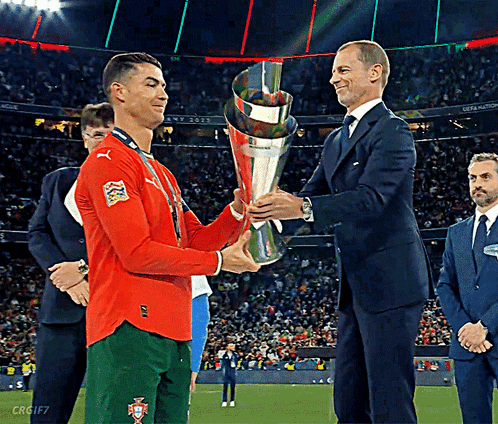 Man in Suit Shaking Hands With Soccer Player