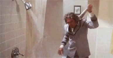 Man In Suit Showering Holding Bat GIF