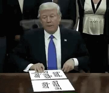 Man In Suit Signing Document At Desk GIF