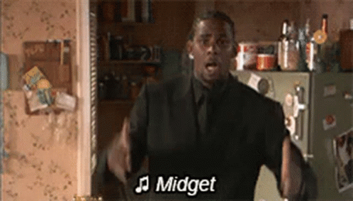 Man in Suit Singing in Front of Refrigerator