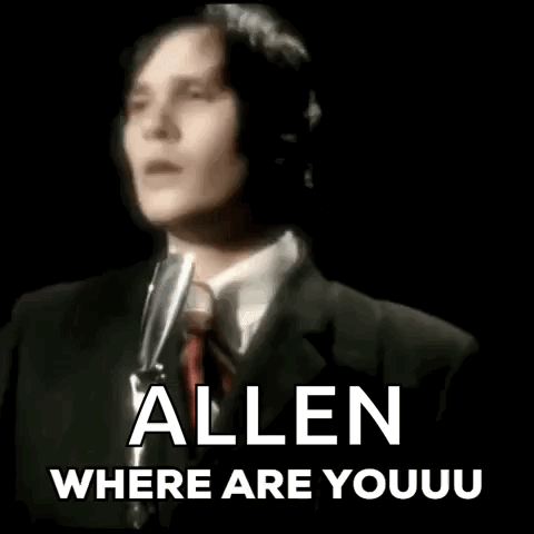 Man in Suit Singing Into Microphone
