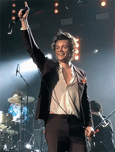 Man in Suit Singing Into Microphone