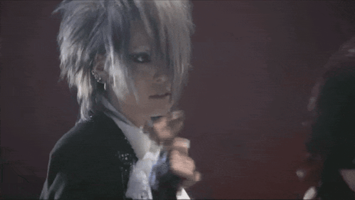 Man In Suit Singing Into Microphone With Gloves GIF