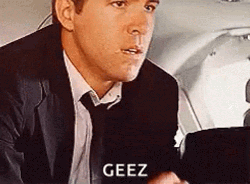 Man In Suit Sitting And Talking In Airplane Back Seat GIF