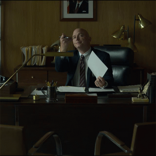 Man in Suit Sitting at Desk
