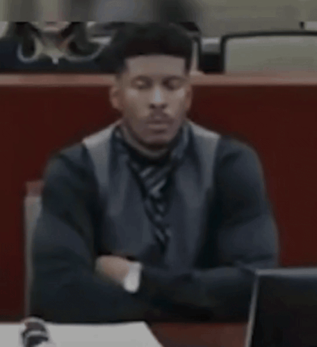 Man in Suit Sitting at Desk With Eyes Closed