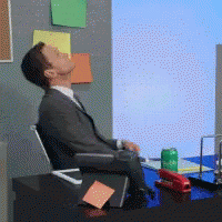 Man in Suit Sitting at Desk with Soda