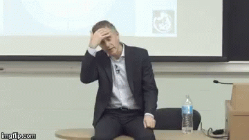 Man In Suit Sitting At Projector Screen GIF