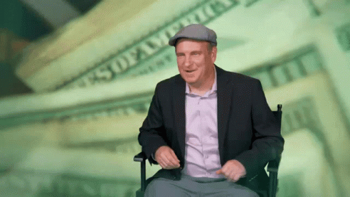 Man in Suit Sitting Before Money