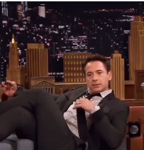 Man in Suit Sitting Cross-Legged
