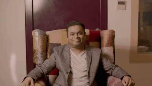 Man in Suit Sitting Crossed Arms