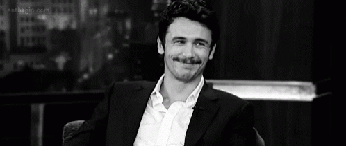 Man In Suit Sitting GIF