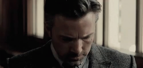 Man In Suit Sitting Eyes Closed By Window GIF