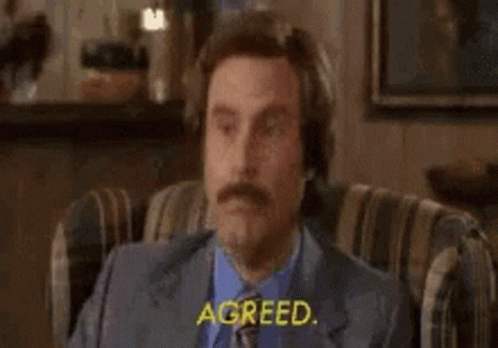 Man in Suit Sitting Eyes Closed Saying Agreed