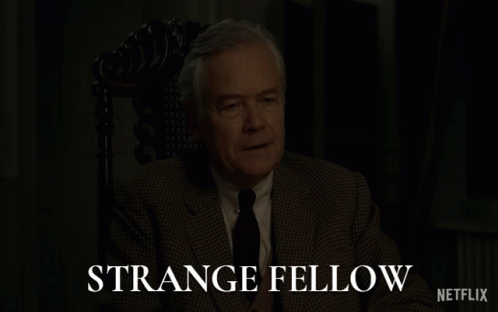 Man in Suit Sitting in Chair Strange Fellow Netflix