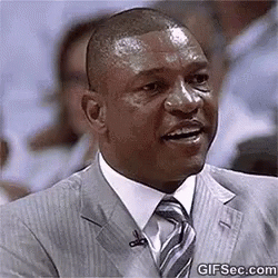 Man In Suit Sitting In Crowd Smiling GIF