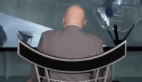 Man In Suit Sitting In Curved Chair GIF