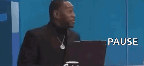 Man in Suit Sitting in Front of Laptop Saying That Was Crazy Pause