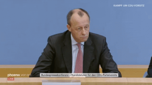 Man in Suit Sitting in Front of Phoenix Vor Ort Live Screen