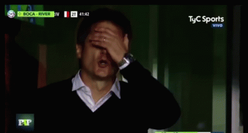 Man in Suit Sitting in Front of Screen Saying El Nueve Vivo