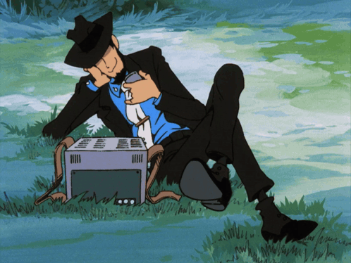 Man In Suit Sitting In Grass With Toaster GIF