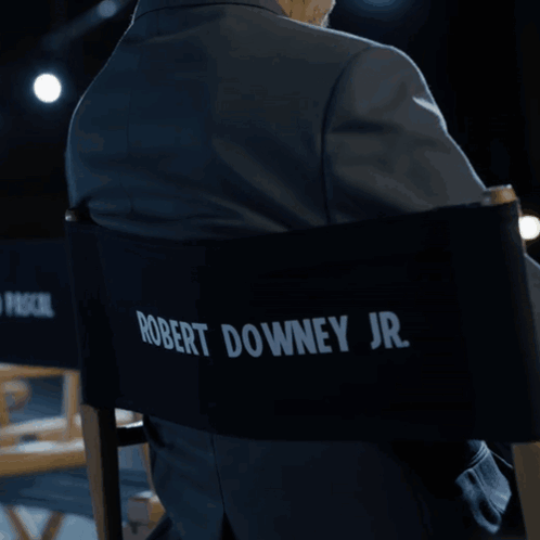 Man in Suit Sitting in Pedro Pascal Jr Chair