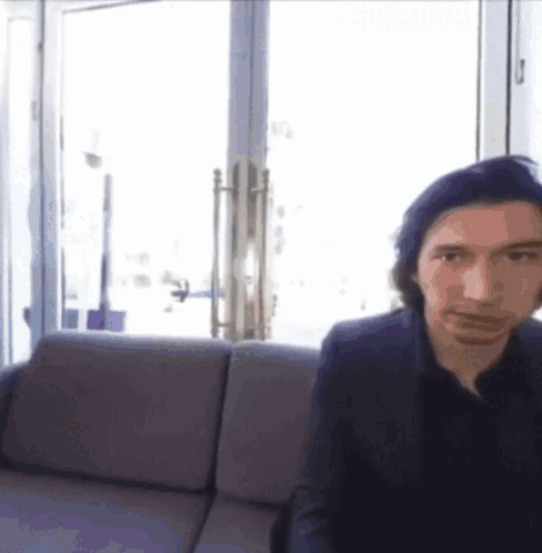 Man In Suit Sitting On Couch By Window GIF