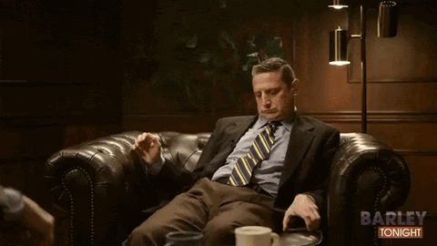 Man in Suit Sitting on Couch Saying Barley Tonight