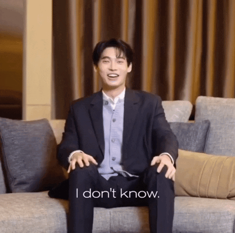Man in Suit Sitting on Couch Saying I Don't Know