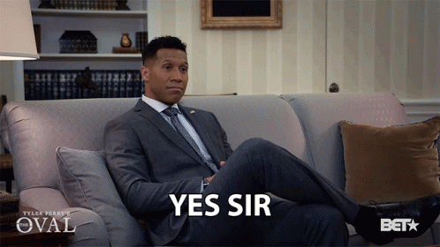 Man in Suit Sitting on Couch Saying Yes Sir