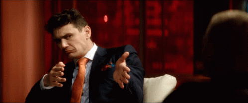 Man In Suit Sitting On Couch GIF