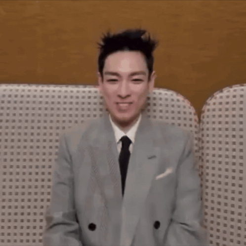 Man in Suit Sitting on Couch With Eyes Closed