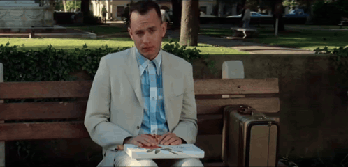 Man In Suit Sitting On Park Bench With Book GIF