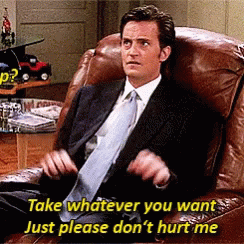 Man in Suit Sitting Saying Take Whatever You Want Just Please Don't Hurt Me