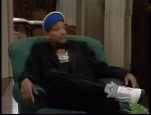 Man in Suit Sitting With Feet Up