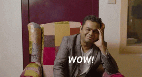 Man in Suit Sitting with Hand on Forehead Wow