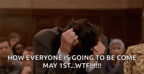 Man In Suit Sitting With Head In Hands GIF