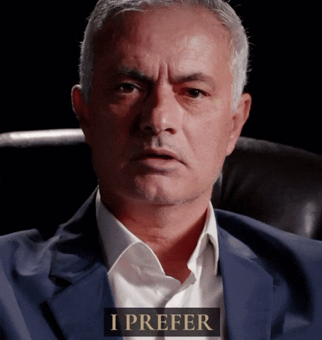 Man in Suit Sitting with I Prefer Sign