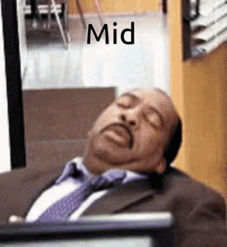 Man in Suit Sleeping in Front of Computer